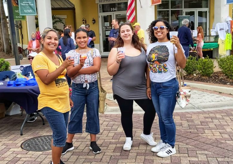 4 women holding up drinks