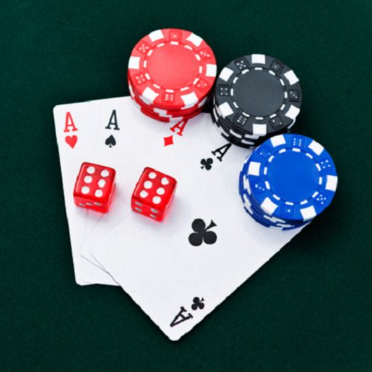 Four ace cards with dice and poker chips