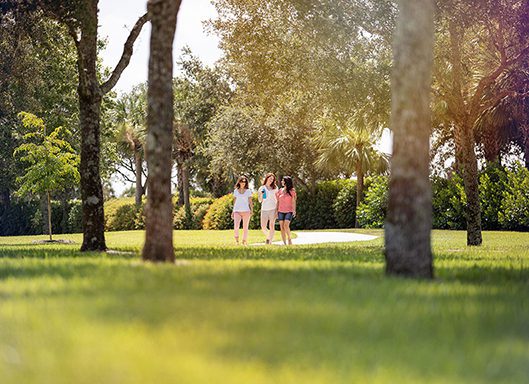 3 women walking in park in Ave Maria, Florida