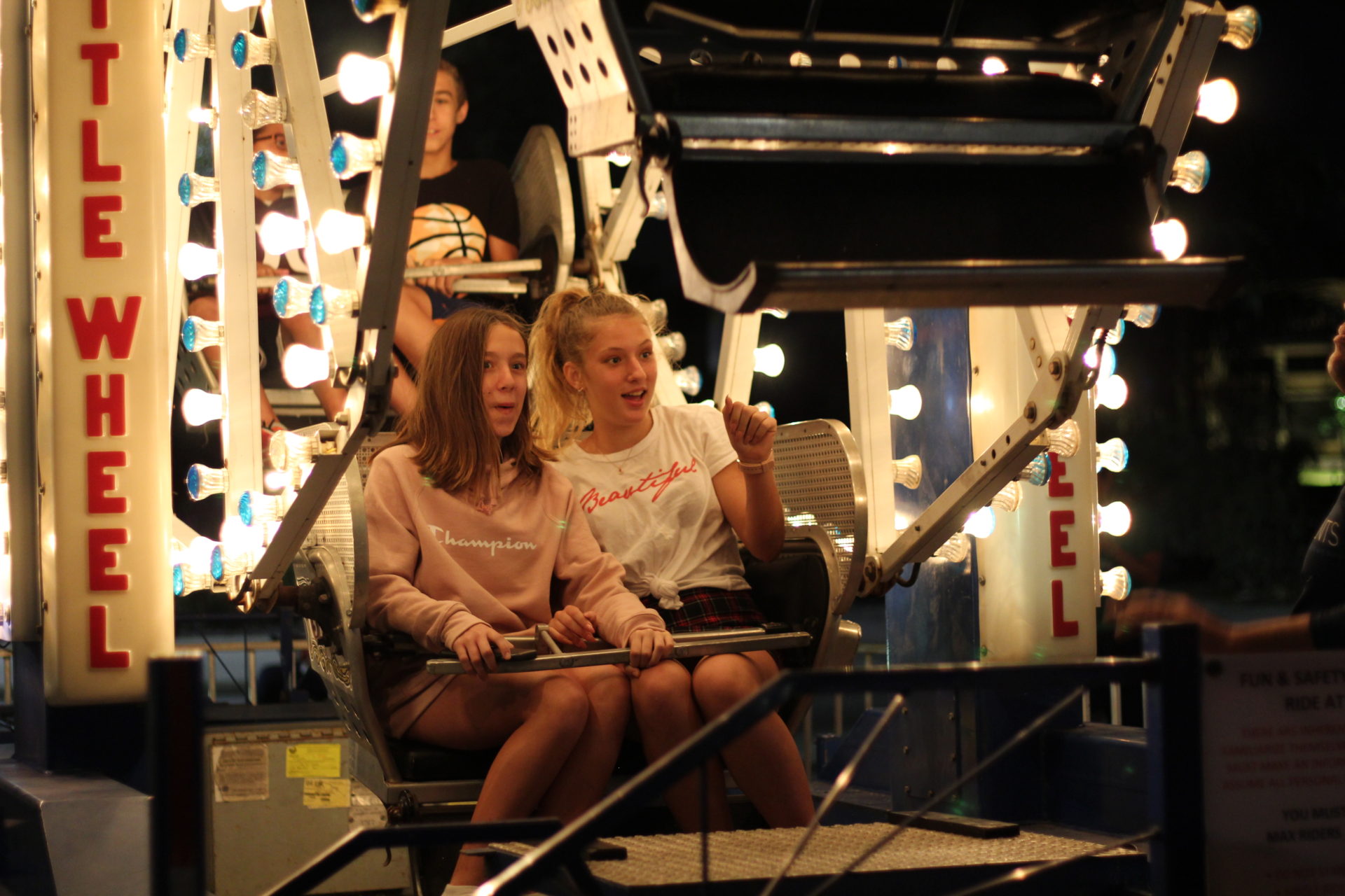 Two girls on mini ferris wheel