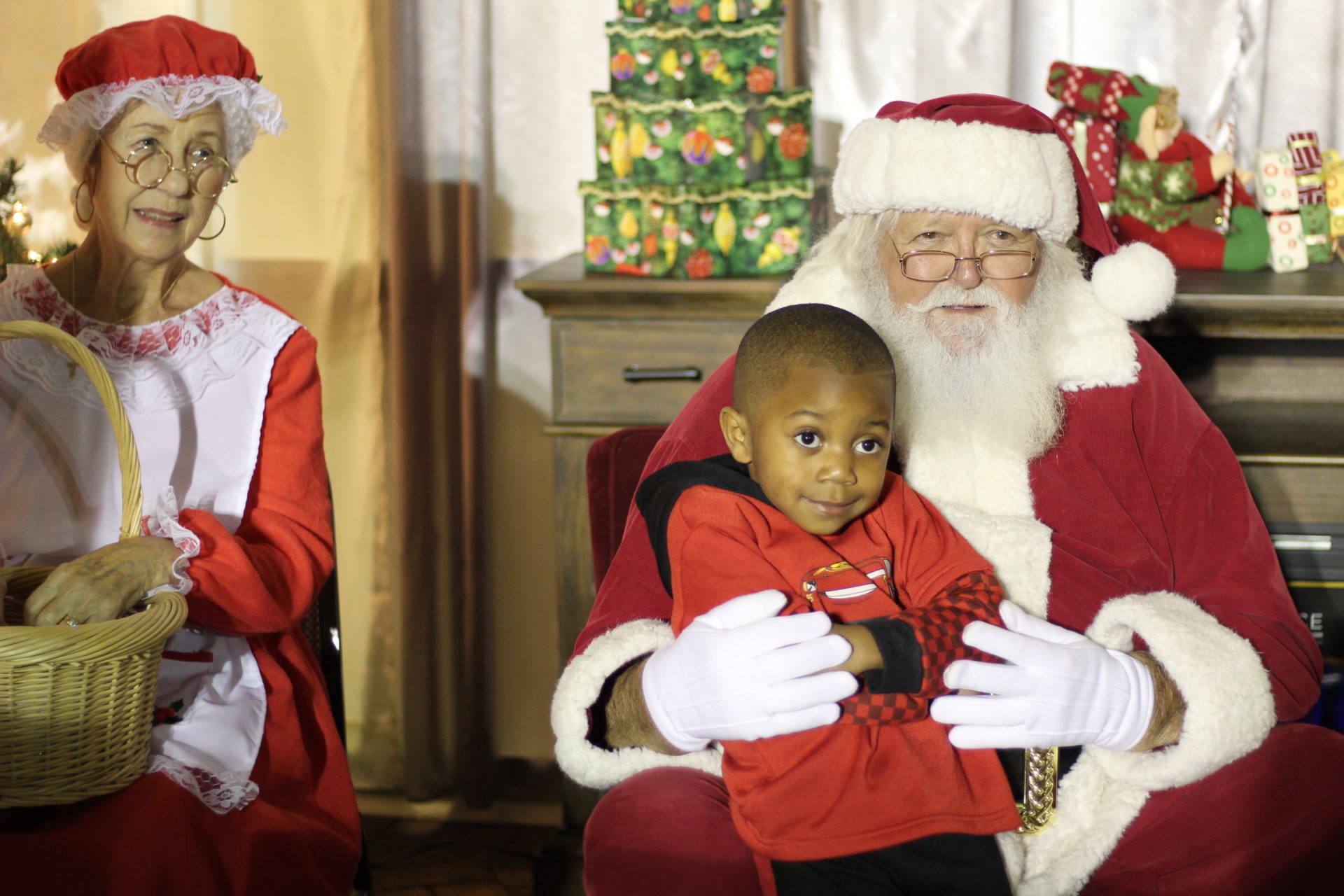 Little boy on Santa's lap, Ms. Claus is in photo too