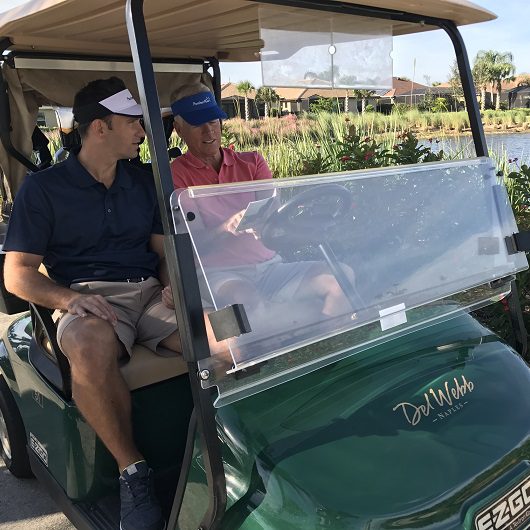 Two men in golf cart Del Webb Naples