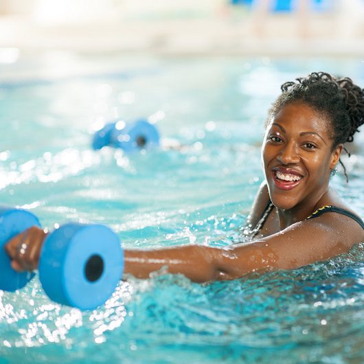 Water Aerobics, women smiling while exercising