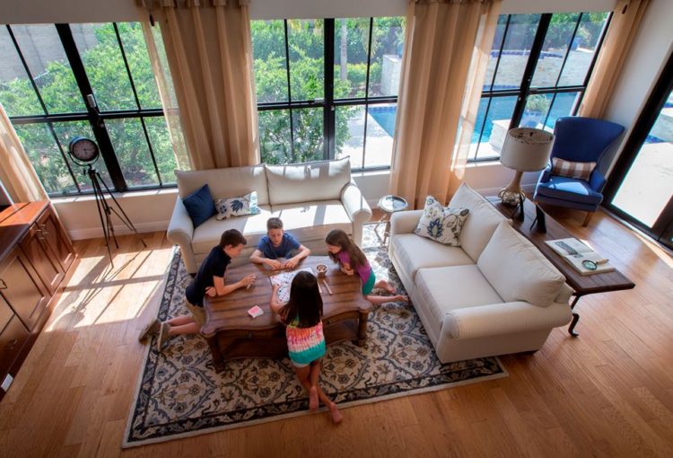 Four children sitting on floor playing Scrabble