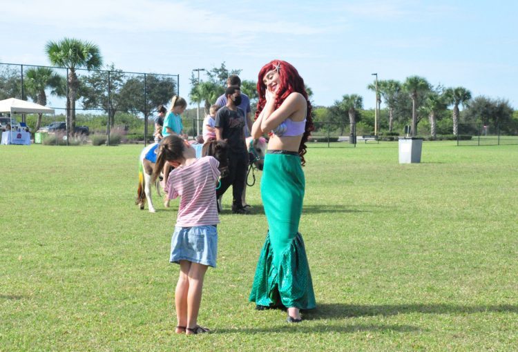 Aerial The Little Mermaid with a young girl at event