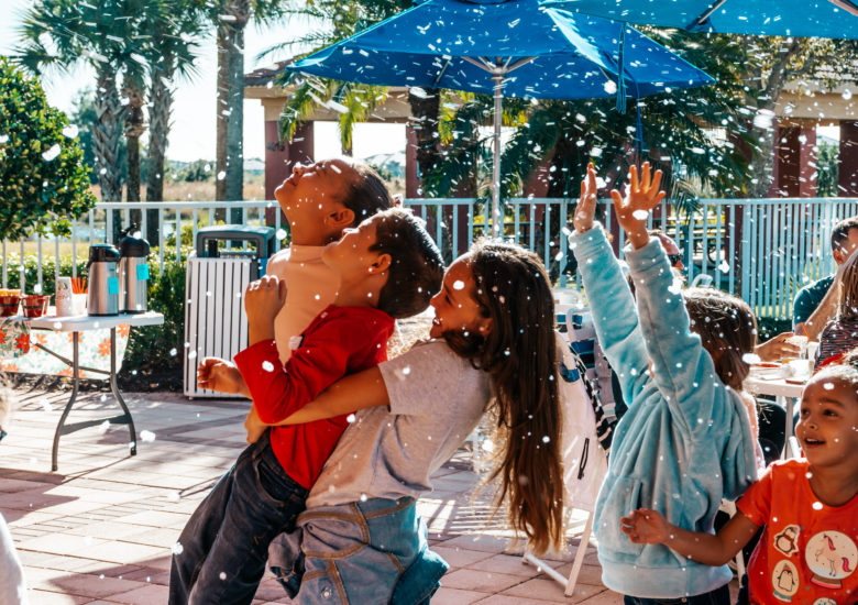 Young children playing with fake snow Ave Maria, Florida