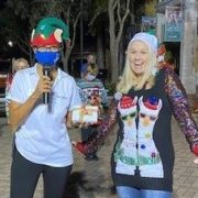 Ugly Christmas Sweater Contest winner posing with MC, Ave Maria, Florida