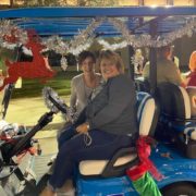 Two women in decorated golf cart