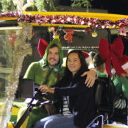 Couple in Christmas decorated golf cart