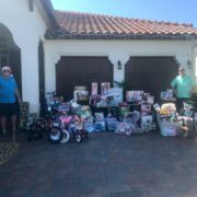 Two men standing next to hundreds of toys in Ave Maria, Florida