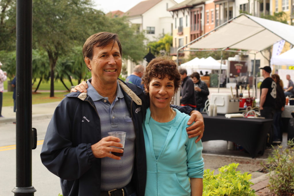 Man and women posing together at outdoor event