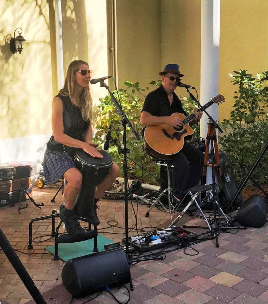 A man and a women singing playing music