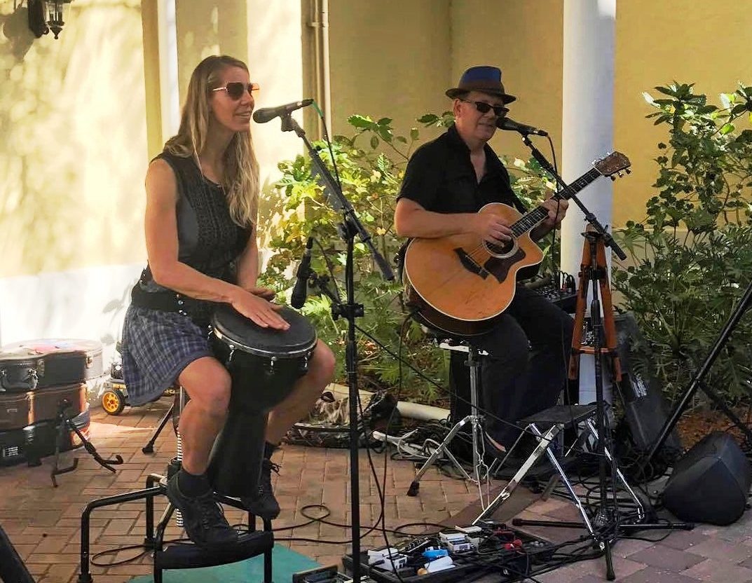 A man and a women singing playing music
