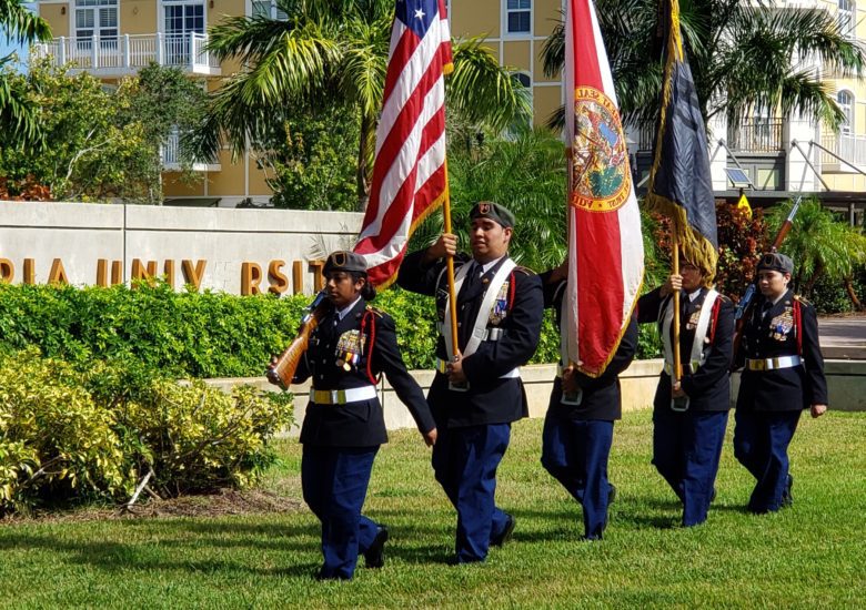 5 US soldiers holding flags