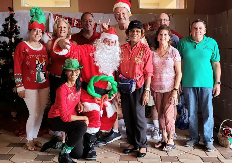 Group of people posing with Santa Claus