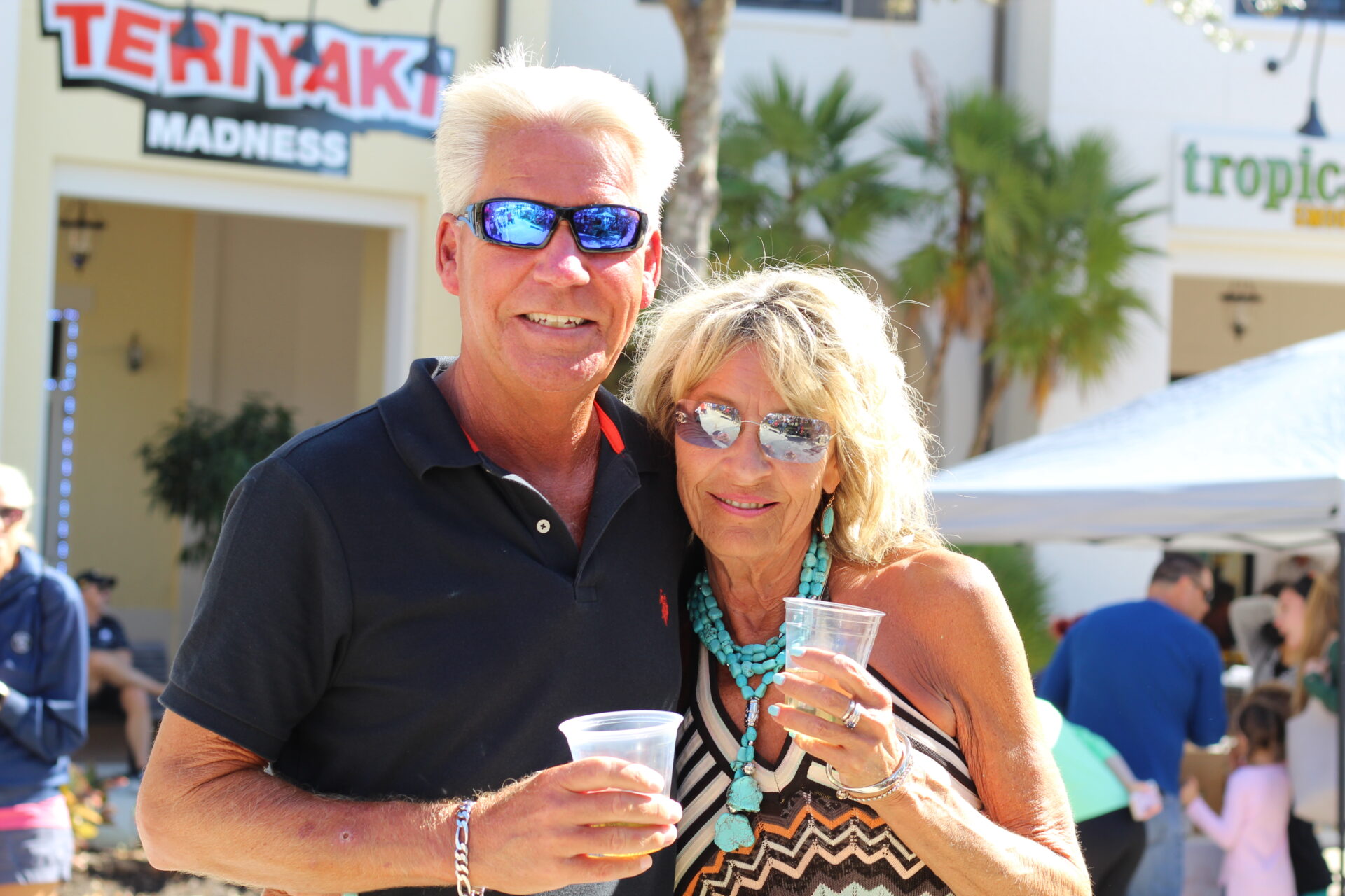 Couple posing with drinks in hand