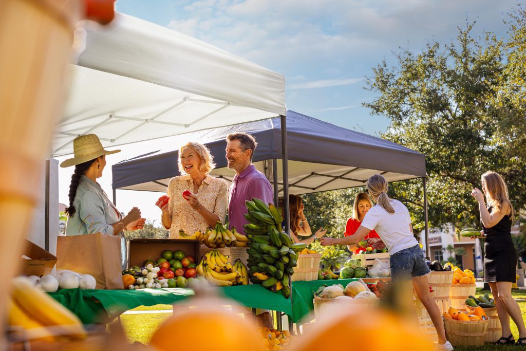 Couple buying produce at farmers market in Ave Maria Florida