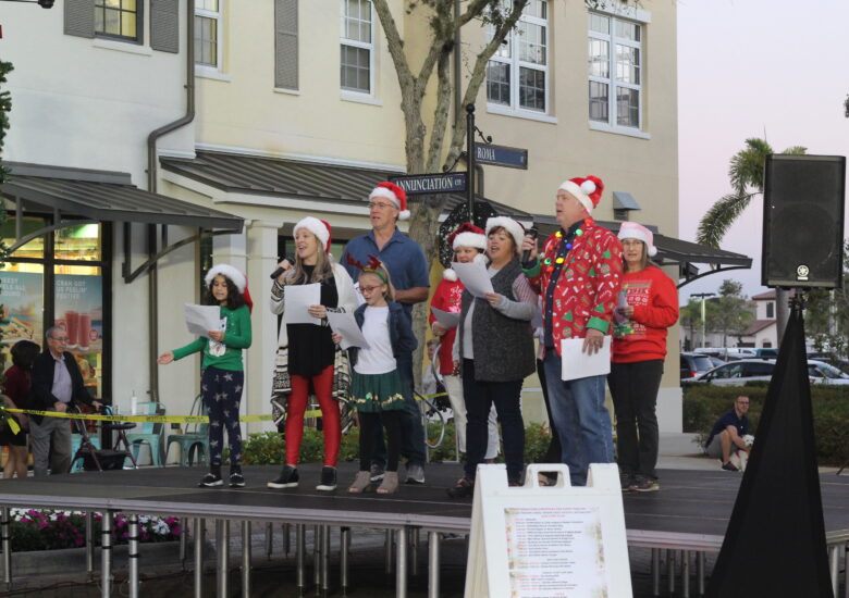 Group of people on stage singing Christmas songs