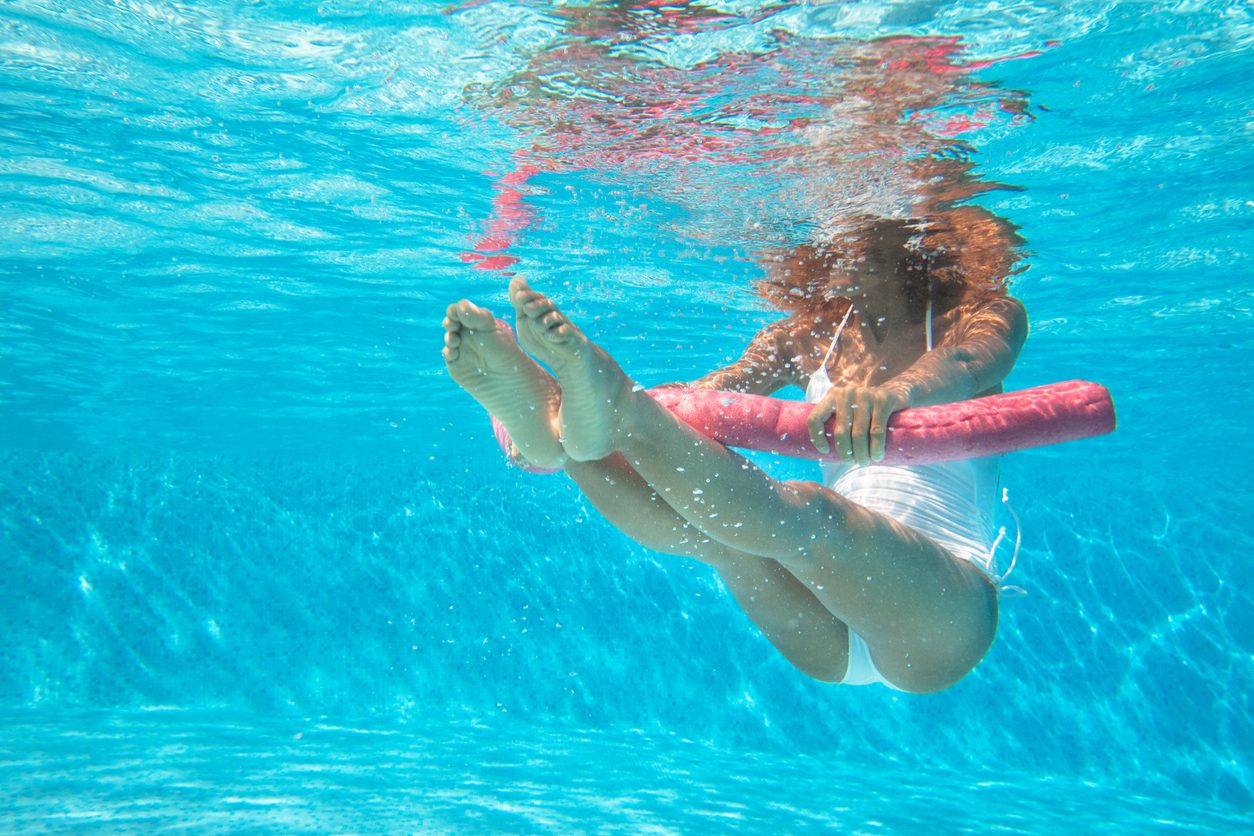 woman doing water aerobics in a pool