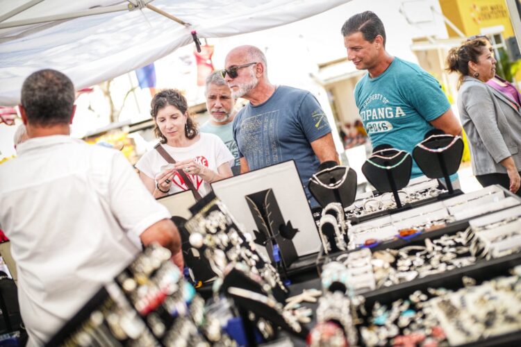 Shoppers view jewelry stand at Arts & Crafts Fest in Ave Maria, FL Town Center