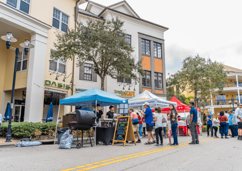 Attendees browsing Taste of Ave vendor tents