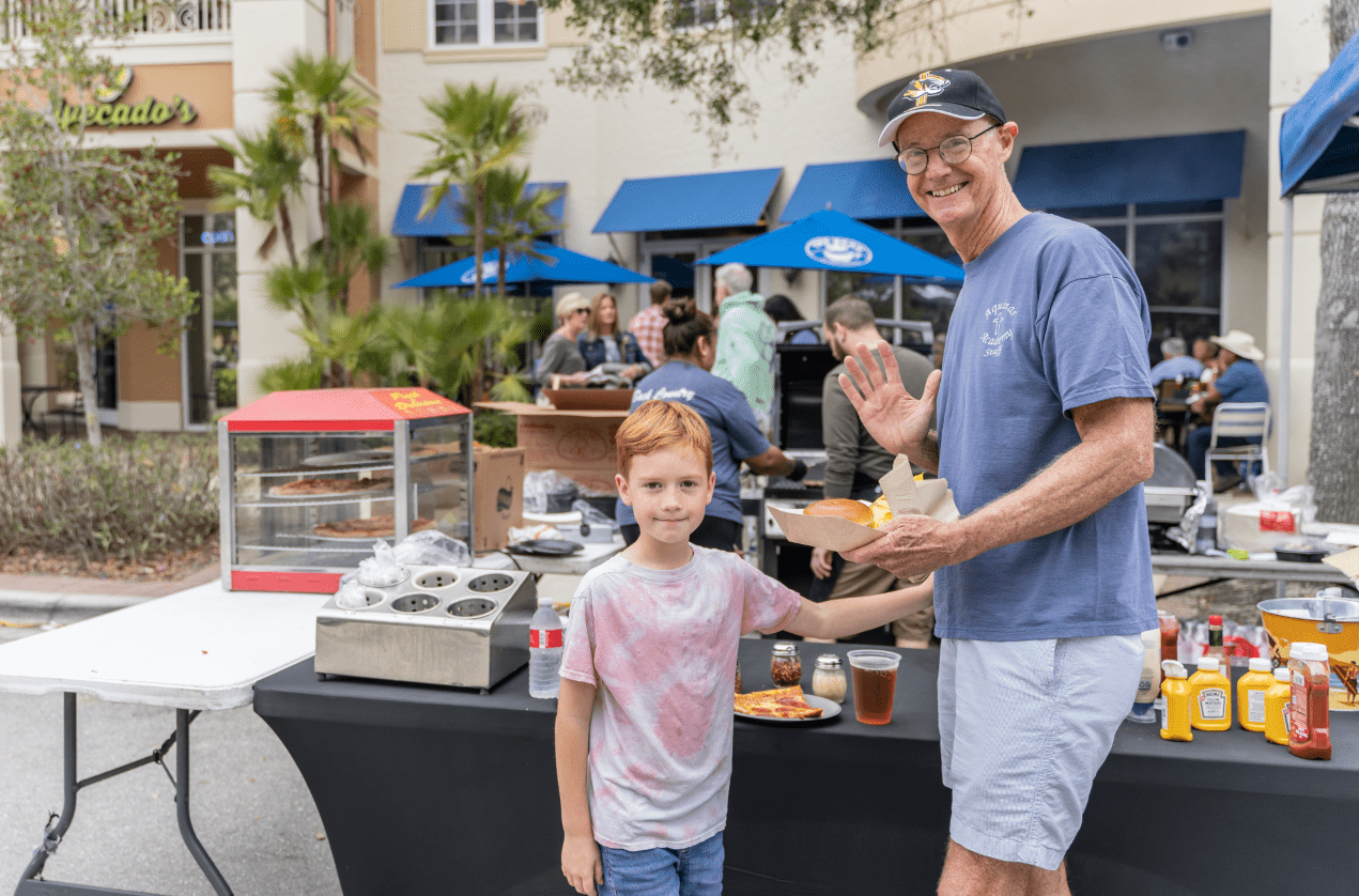 Father and son grabbing pizza and hamburgers at Taste of Ave