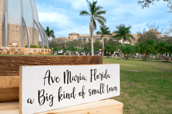 Sign that reads, "Ave Maria, Florida a Big kind of small town"
