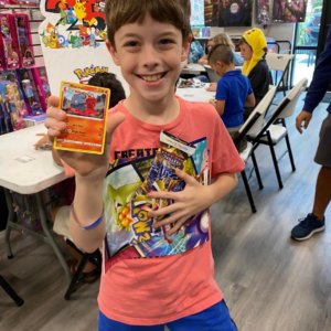 A kid holding a Pokèmon card