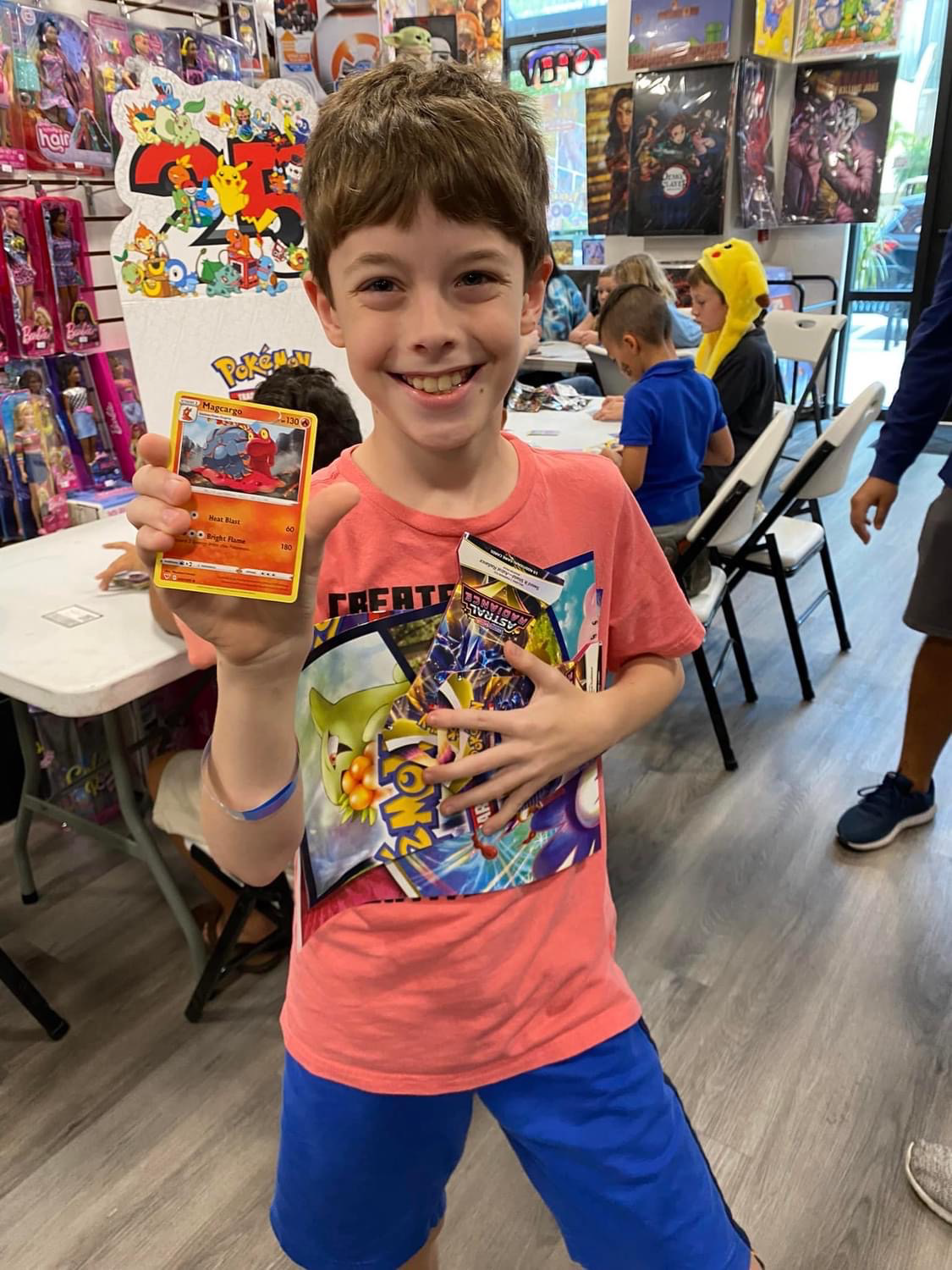 A kid holding a Pokèmon card