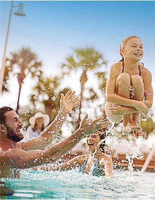 Man tossing a woman in a pool