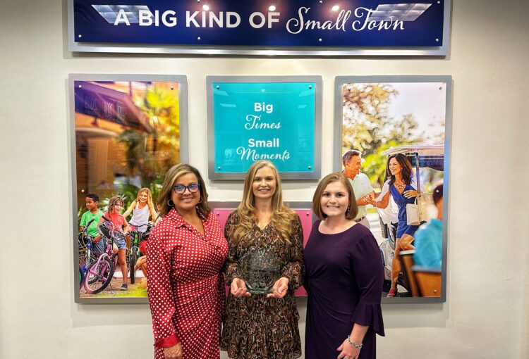 Ave Maria Development team members holding award - Monica Villa, Donna Marquez, Erica Fis