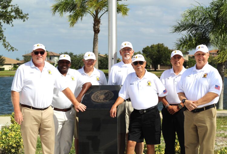 Ave Maria Vets stand in center of Ave Maria Veterans Memorial