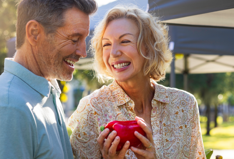 Couple buys fresh vegetables at the Ave Maria, FL farmers market