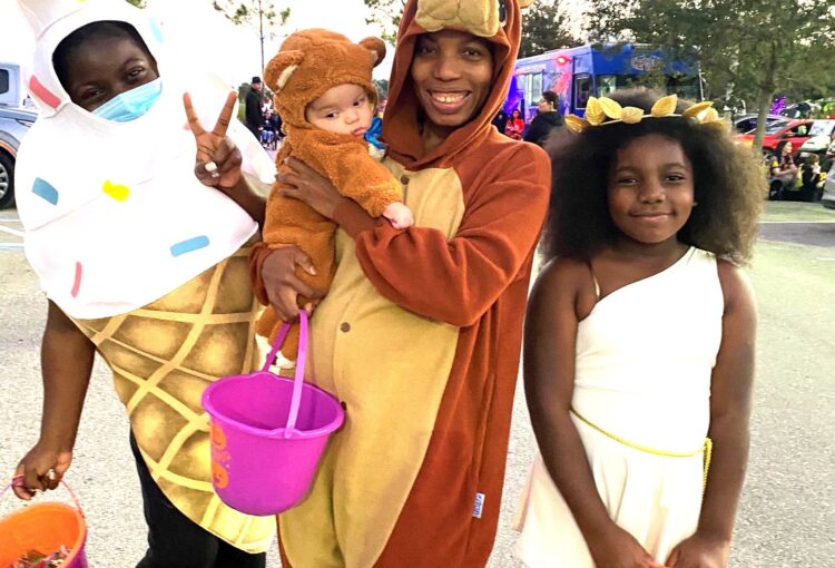 Family dressed in costumes at Ave Maria Trunk or Treat