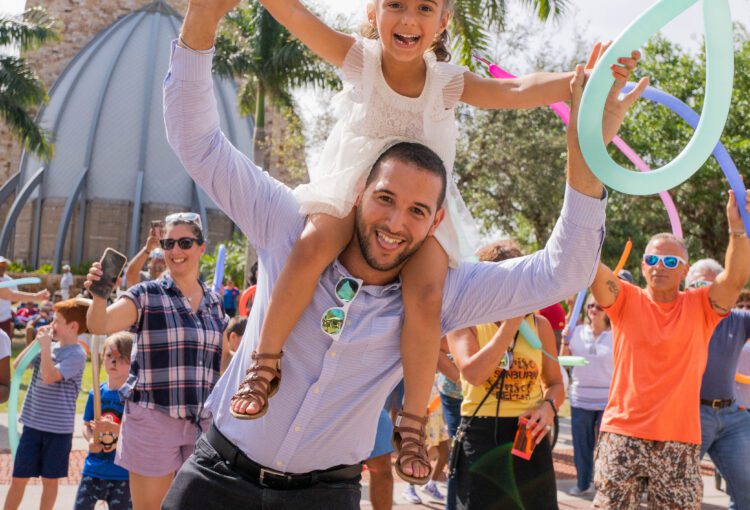 Father and daughter with balloon and dancing at the 2023 Margarita & Taco Festival