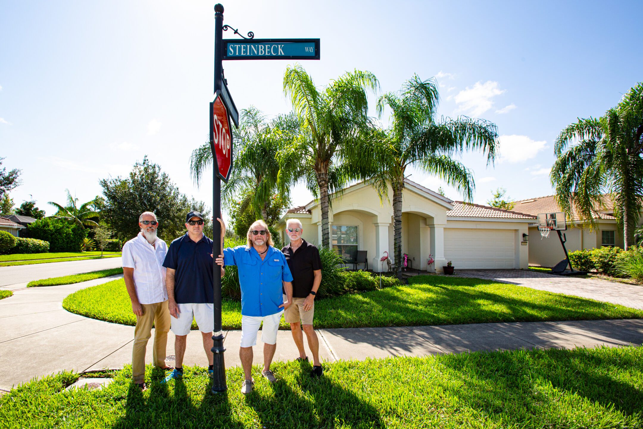 Steinbeck Way - Four men standing by street sign