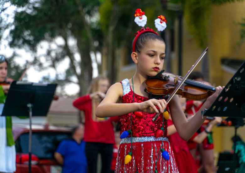 Young girl plays the violin at Hometown Christmas
