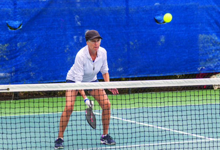 Woman plays pickleball at Del Webb Naples court