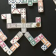 Mexican Train Dominoes Game on black table surface