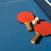 Ping pong paddles, two piing pong balls and ping pong table