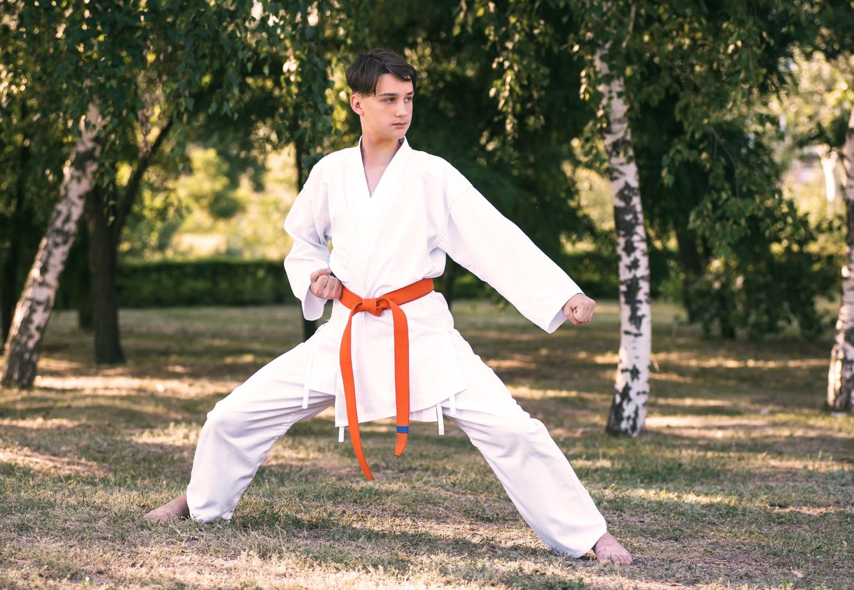 boy practicing martial arts outdoors