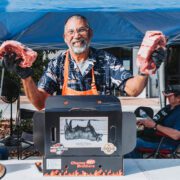 Man holds up steaks he'll cook in the 2026 Sunshine State Steak Cook-Off
