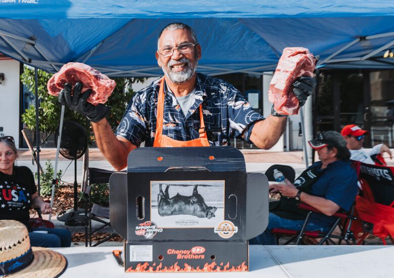 Man holds up steaks he'll cook in the 2026 Sunshine State Steak Cook-Off competition