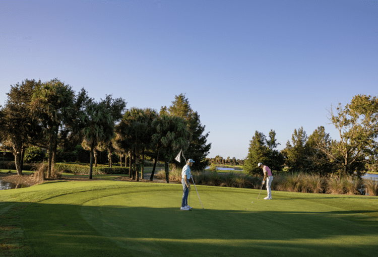 Two friends play a round of golf at Panther Run Golf Club