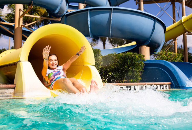 Young Ave Maria resident slides down water slide at Water Park